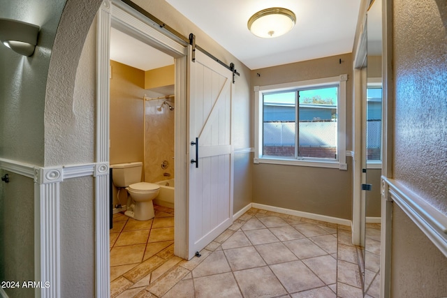 bathroom featuring tile patterned flooring, shower / bath combination, and toilet