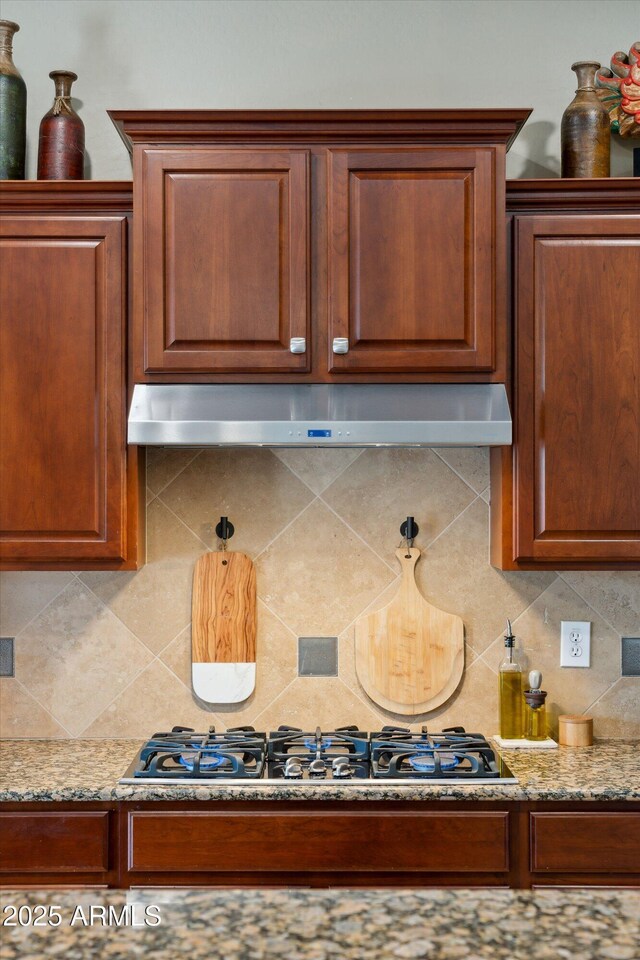 27308 N 56th Dr, Phoenix, AZ 85083 - kitchen view of under cabinet range hood, black gas cooktop, decorative backsplash, and light stone countertops