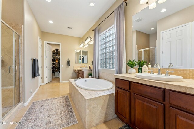27308 N 56th Dr, Phoenix, AZ 85083 - bathroom featuring a stall shower, a bath, tile patterned floors, two vanities, and a walk in closet