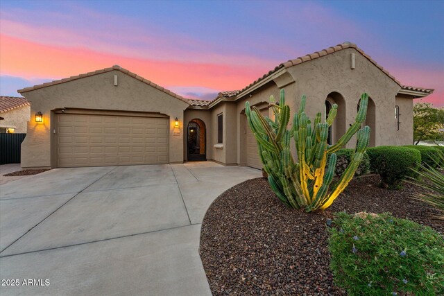 27308 N 56th Dr, Phoenix, AZ 85083 - mediterranean / spanish-style home featuring an attached garage, concrete driveway, and a tile roof