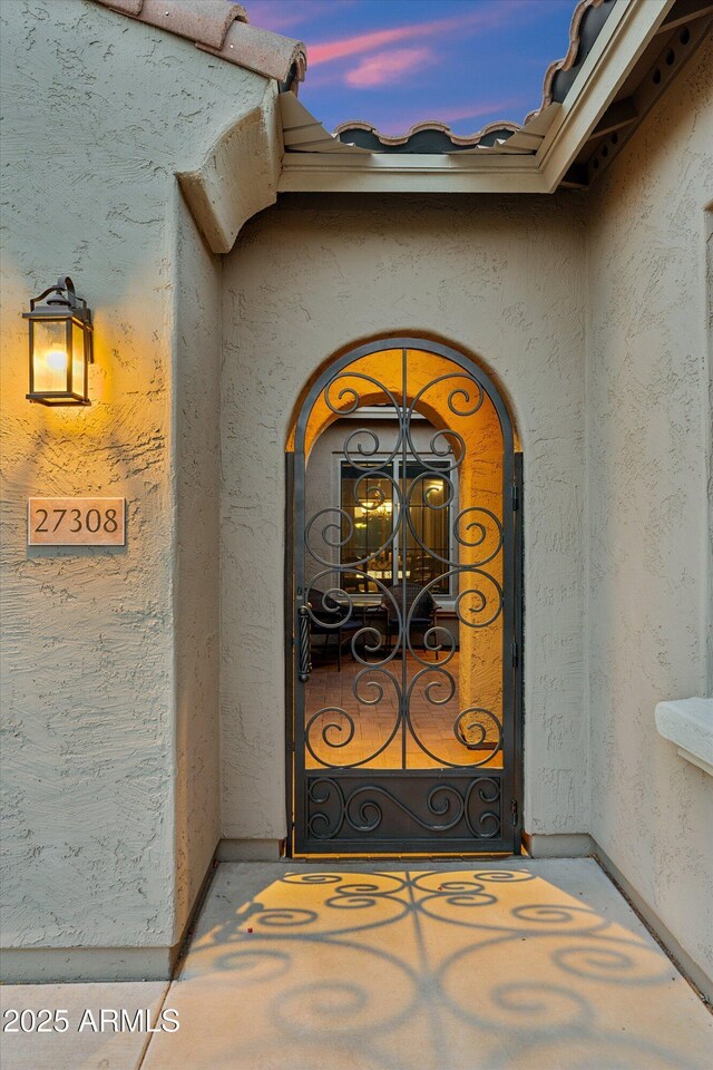 27308 N 56th Dr, Phoenix, AZ 85083 - exterior entry at dusk featuring stucco siding