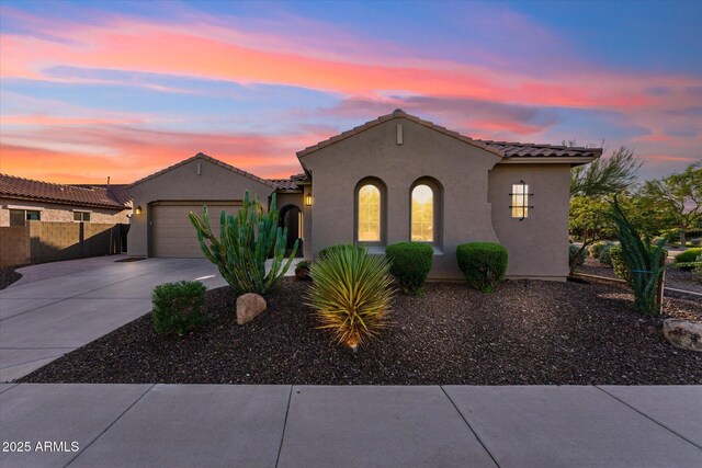 27308 N 56th Dr, Phoenix, AZ 85083 - mediterranean / spanish-style house featuring concrete driveway, stucco siding, an attached garage, fence, and a tile roof
