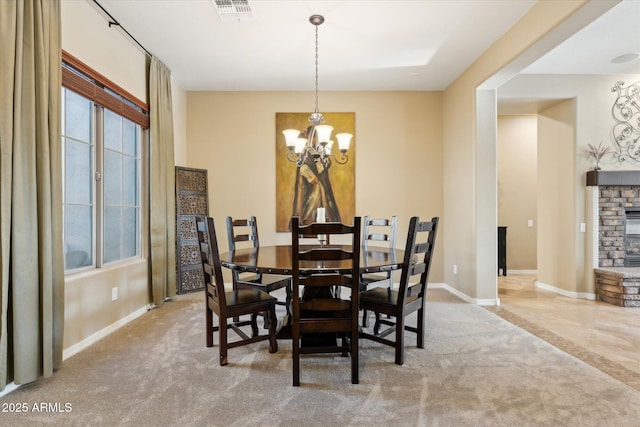 27308 N 56th Dr, Phoenix, AZ 85083 - carpeted dining room with baseboards, a chandelier, and a fireplace