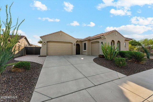 27308 N 56th Dr, Phoenix, AZ 85083 - mediterranean / spanish house with a garage, concrete driveway, stucco siding, a tiled roof, and fence