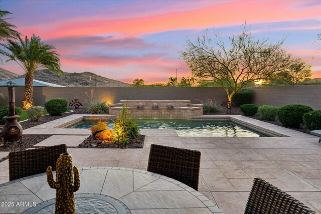 27308 N 56th Dr, Phoenix, AZ 85083 - pool at dusk with a patio and a fenced backyard
