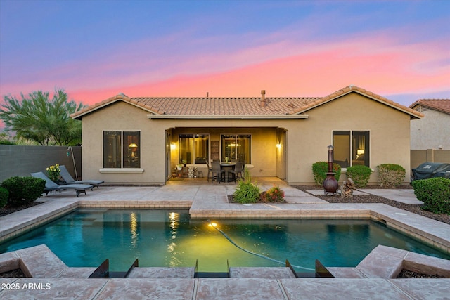 27308 N 56th Dr, Phoenix, AZ 85083 - back of property at dusk featuring a tile roof, stucco siding, and fence