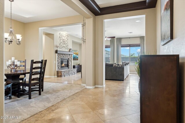 27308 N 56th Dr, Phoenix, AZ 85083 - tiled dining room featuring a stone fireplace, a chandelier, and baseboards