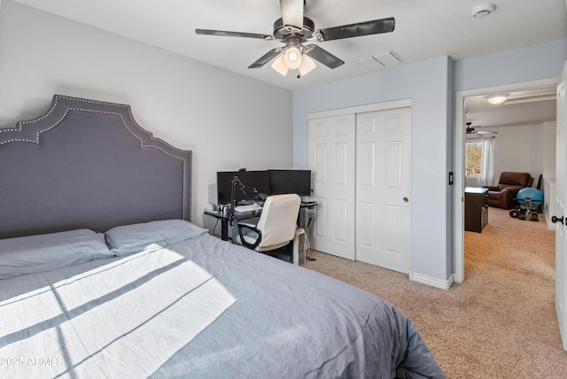 bedroom featuring a ceiling fan, a closet, light carpet, and visible vents