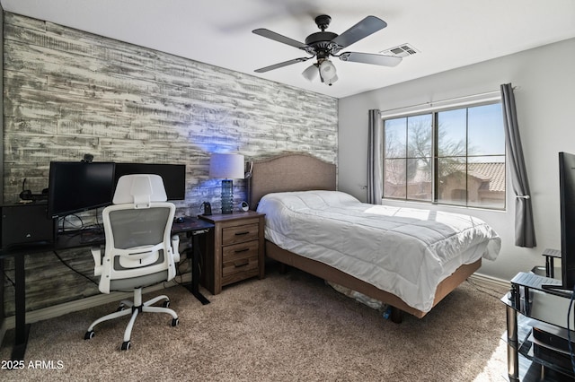 bedroom featuring wallpapered walls, baseboards, visible vents, an accent wall, and carpet floors