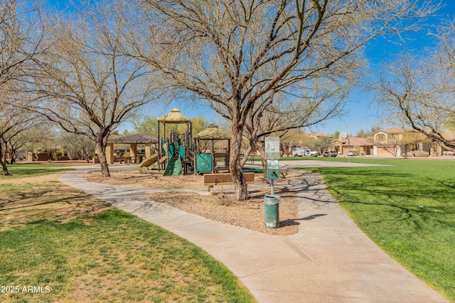 view of home's community with playground community and a yard