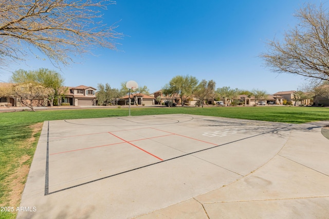 view of home's community with community basketball court, a residential view, concrete driveway, and a yard