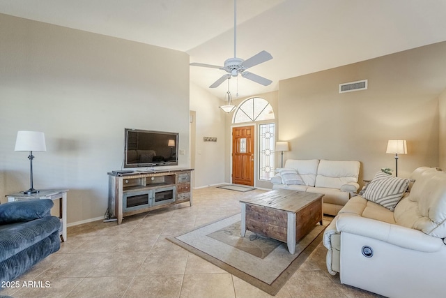 tiled living room featuring ceiling fan and vaulted ceiling