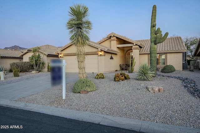 view of front of property featuring cooling unit and a garage