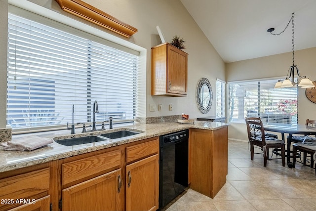 kitchen with pendant lighting, dishwasher, sink, vaulted ceiling, and light stone countertops