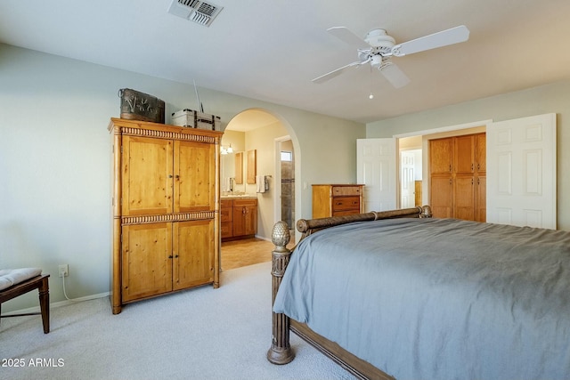 carpeted bedroom featuring connected bathroom, ceiling fan, and sink