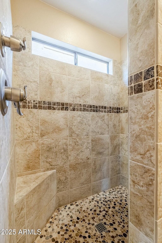 bathroom featuring tiled shower