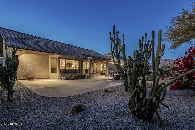 back of property with a patio