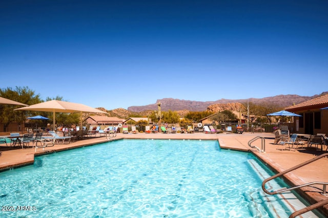 view of pool with a mountain view and a patio