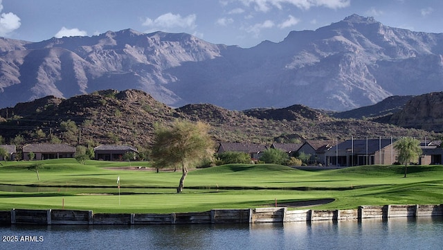 view of community with a water and mountain view and a lawn