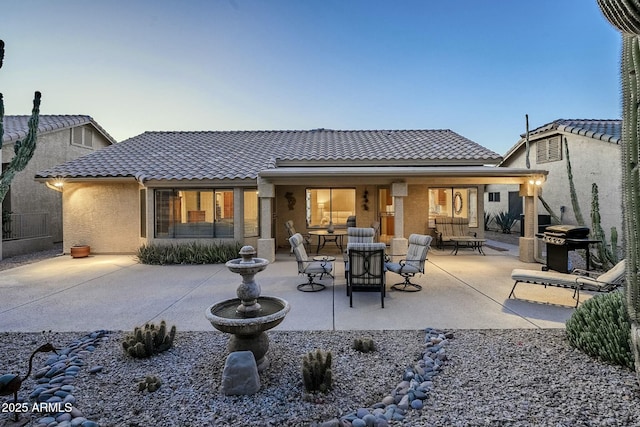 rear view of property featuring a patio