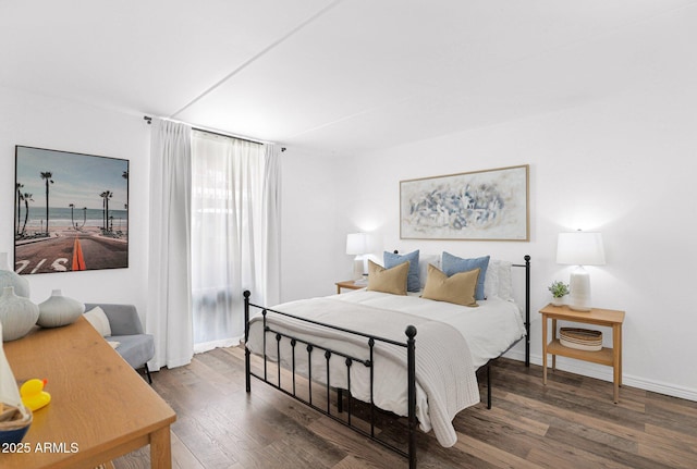 bedroom with wood finished floors and baseboards