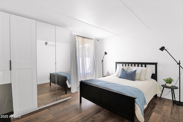 bedroom featuring dark wood finished floors