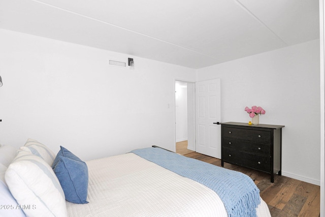 bedroom with wood finished floors