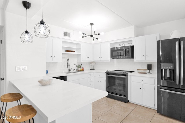 kitchen featuring visible vents, stainless steel microwave, fridge with ice dispenser, electric range, and a sink