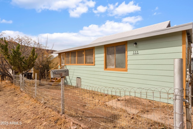 view of property exterior featuring fence