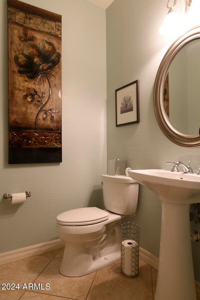 bathroom with toilet and tile patterned flooring