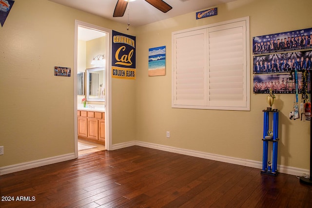 empty room with dark hardwood / wood-style flooring and ceiling fan