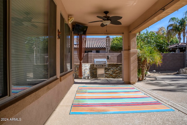 view of patio featuring grilling area, ceiling fan, and exterior kitchen