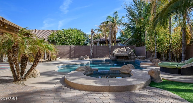 view of pool featuring a patio and an in ground hot tub