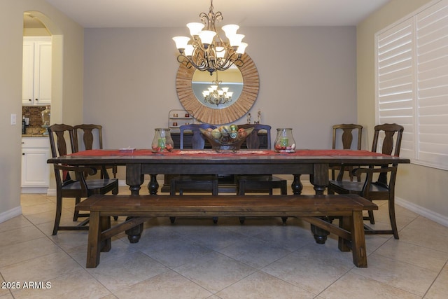 dining space featuring an inviting chandelier and light tile patterned floors