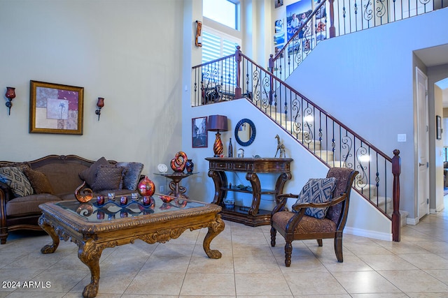 tiled living room featuring a high ceiling