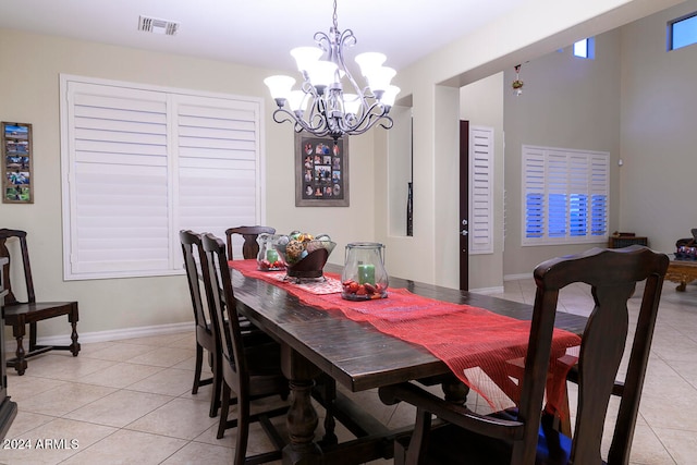 dining area with light tile patterned floors and a notable chandelier