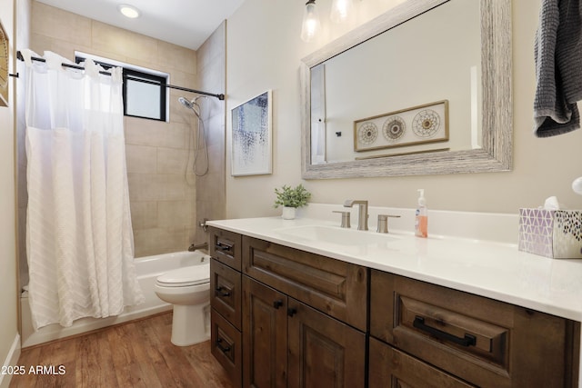 full bathroom featuring shower / tub combo with curtain, vanity, hardwood / wood-style flooring, and toilet