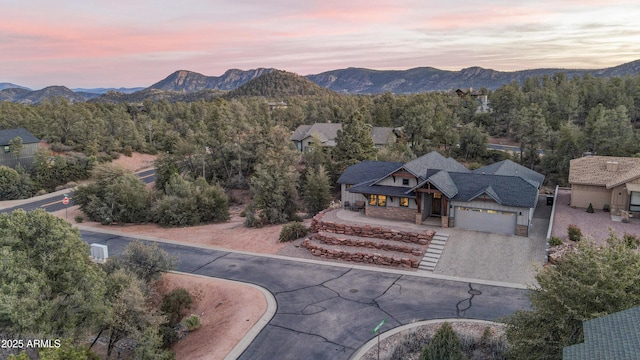 aerial view at dusk featuring a mountain view