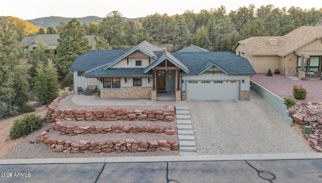 craftsman inspired home with a garage and a mountain view