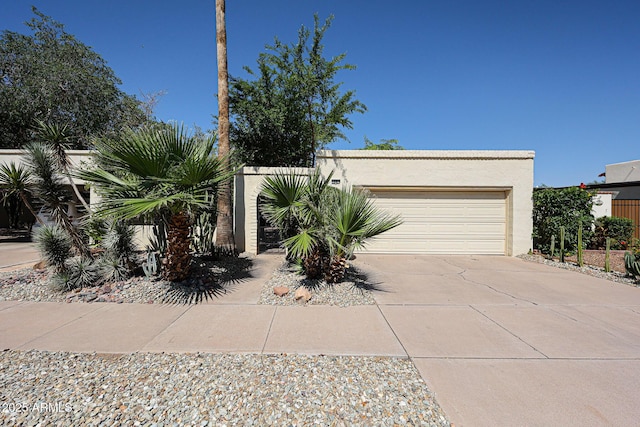 1500 N Markdale Unit 68, Mesa, AZ 85201 - view of front of home featuring concrete driveway, stucco siding, and a garage