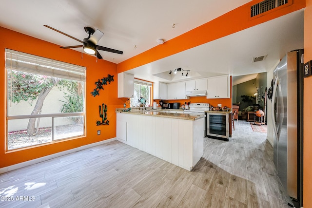 1500 N Markdale Unit 68, Mesa, AZ 85201 - kitchen with freestanding refrigerator, white range with electric cooktop, a peninsula, wine cooler, and light wood finished floors