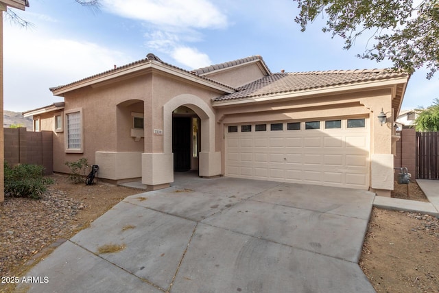 mediterranean / spanish home featuring a garage