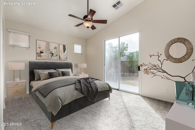 carpeted bedroom featuring access to outside, vaulted ceiling, and ceiling fan