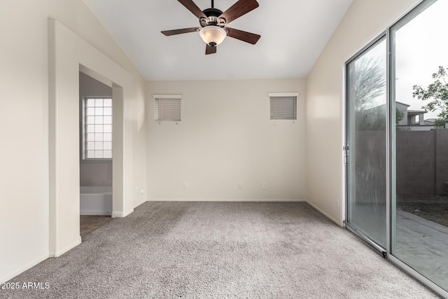 carpeted spare room with ceiling fan