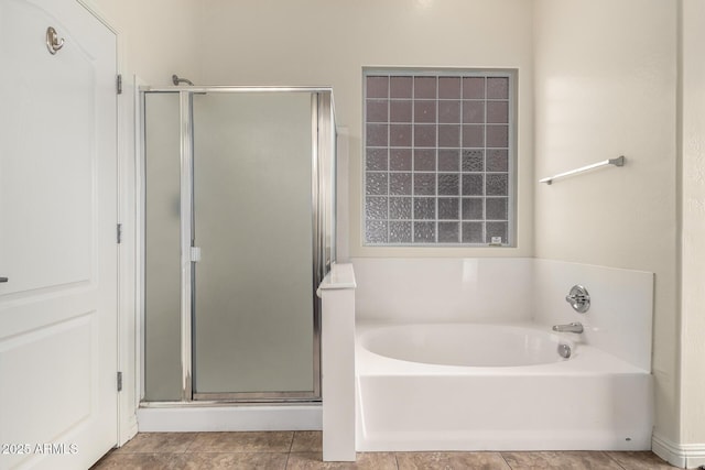 bathroom featuring tile patterned floors and independent shower and bath