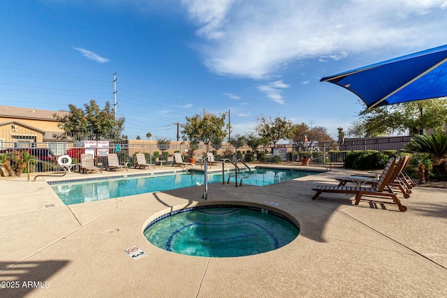 view of swimming pool with a patio and a hot tub