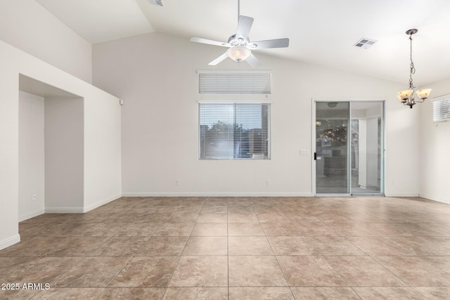 empty room with light tile patterned floors, ceiling fan with notable chandelier, and vaulted ceiling