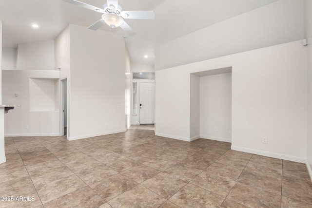 empty room with ceiling fan and lofted ceiling