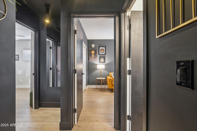 hallway with light hardwood / wood-style floors