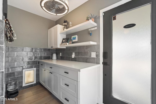 kitchen featuring white cabinets, tasteful backsplash, and dark wood-type flooring